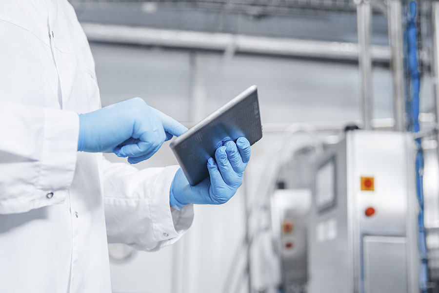 person conducting an audit in a manufacturing facility