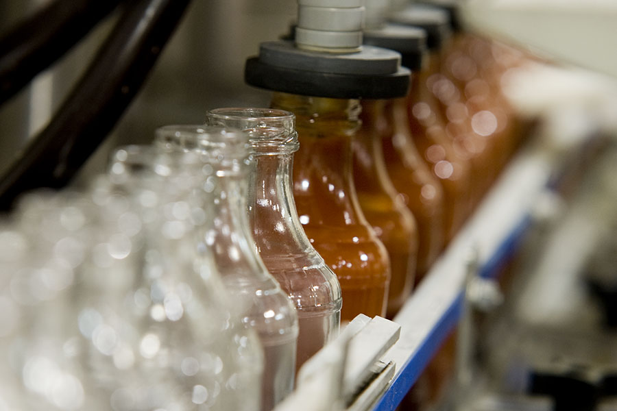 bottles being filled with sauce